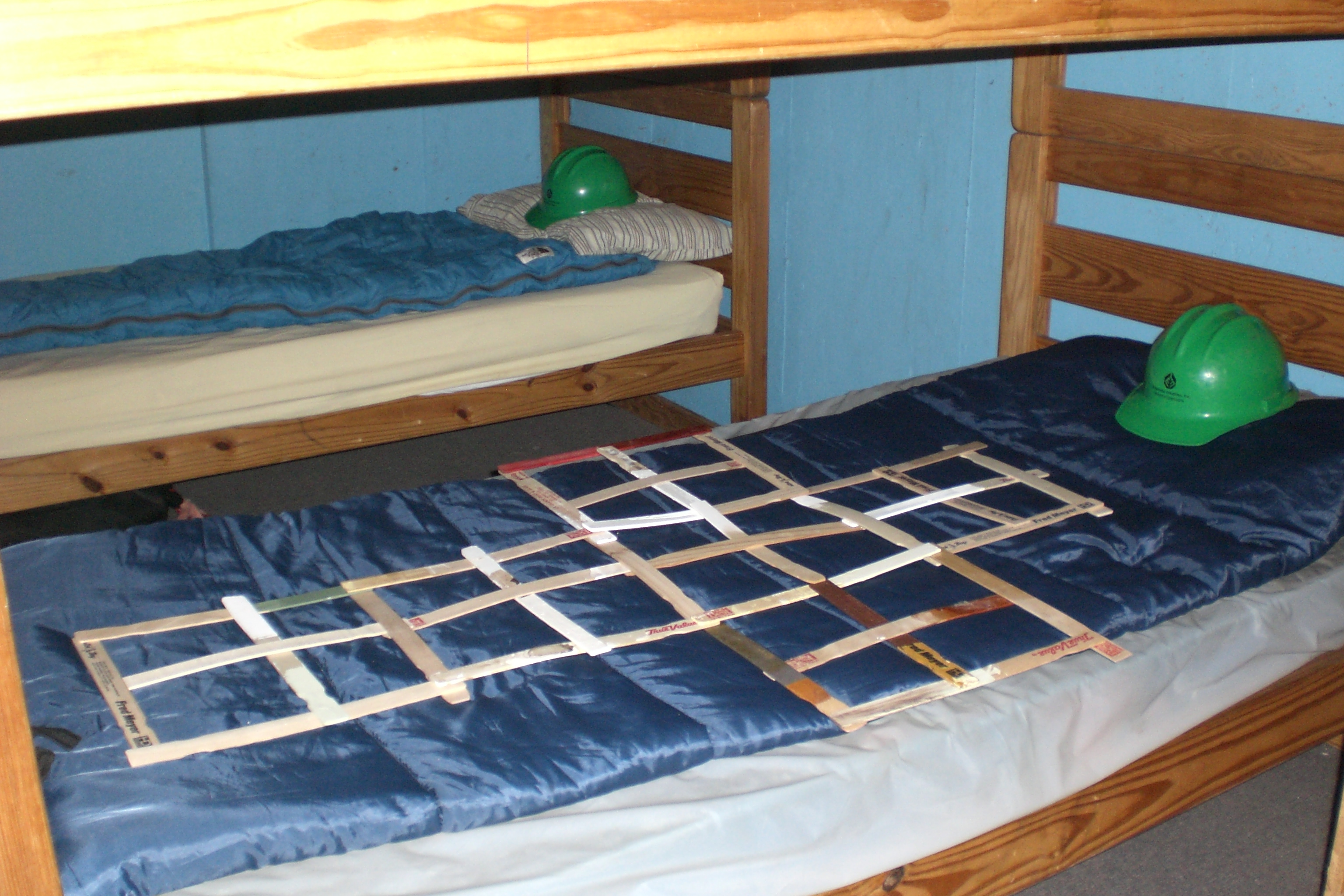 decorations, including hardhats, on dorm bunks