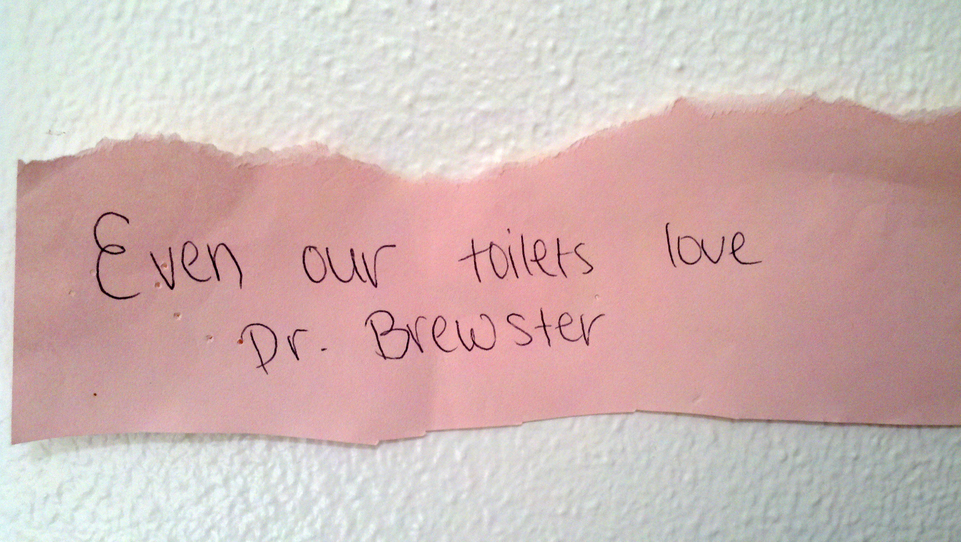 Scrap of paper that reads: Even our toilets love Dr Brewster