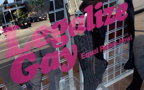 Shop window with "legalize gay" slogan