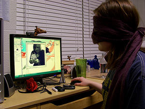 A blindfolded girl editing an image