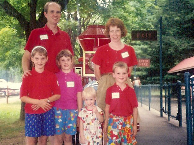 author with siblings and parents in front of train