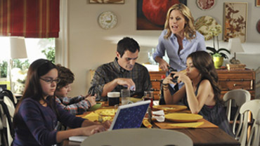 Nearly each family plugged into digital devices sitting at the dining room table